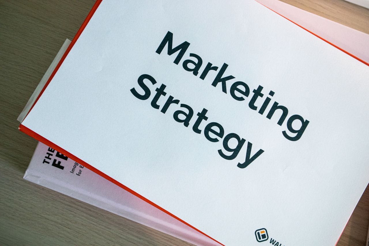services-04 A marketing strategy document displayed on a desk, showcasing business planning essentials.